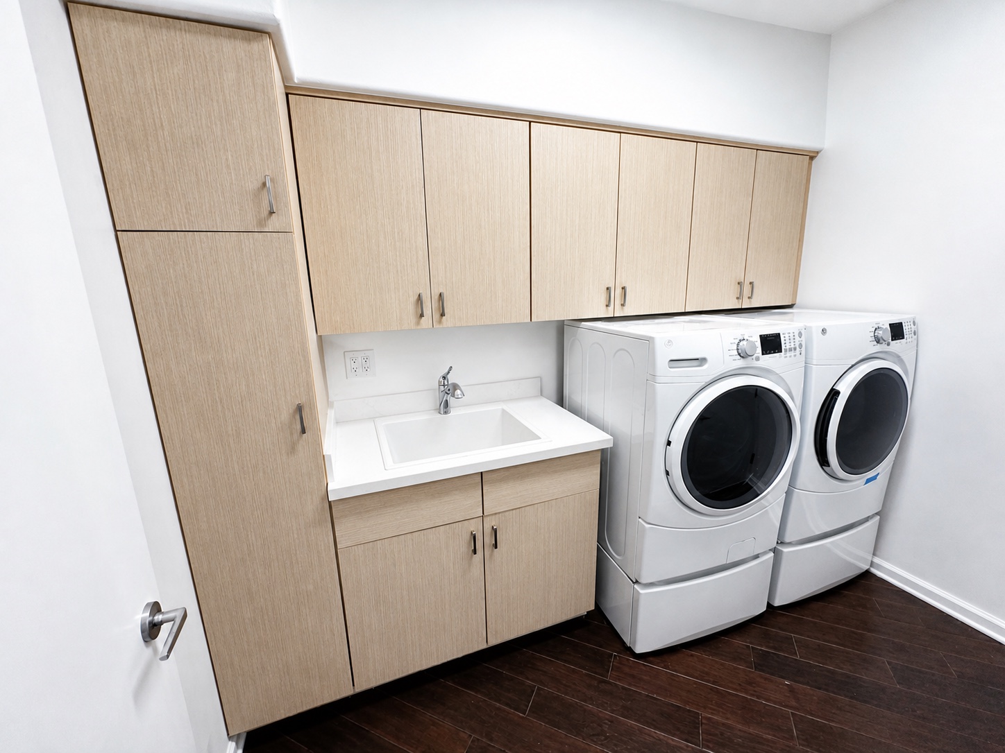 Completed Scottsdale laundry cabinetry in light wood architectural film